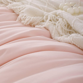 Dorm room styling with ROSGONIA blush comforter and pillows.