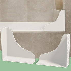 Roslim no-adhesive splash guard with suction cups seals shower corners to keep floors dry.