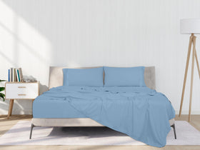 Royale Linens lake blue full sheets pillow setup enhances bedroom ambiance.