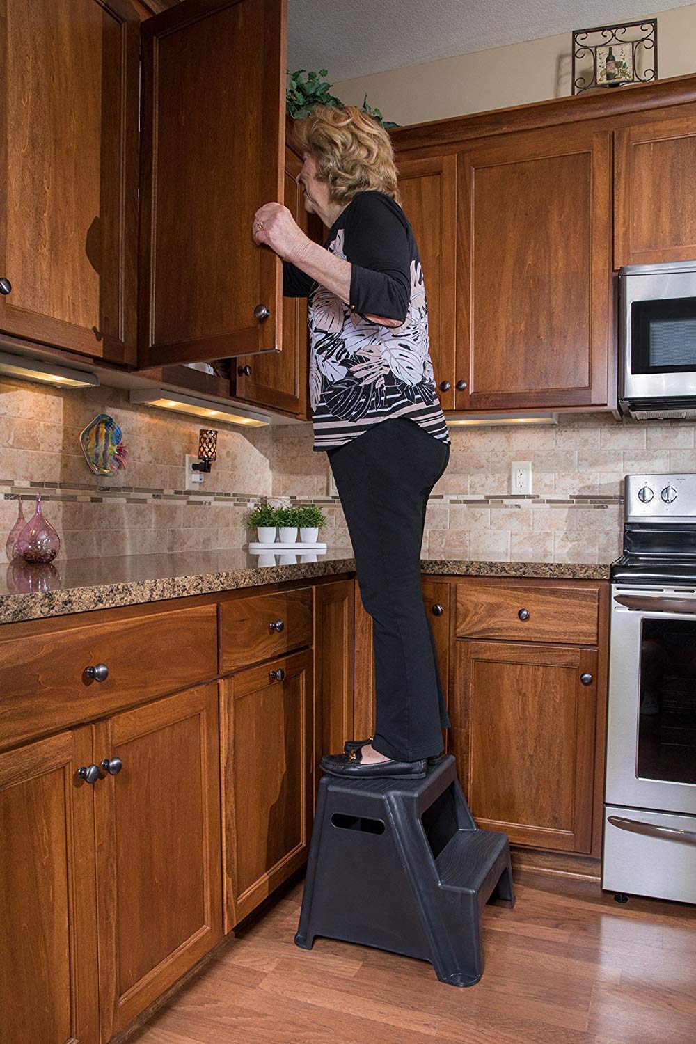 Rubbermaid 2-step stool features cut-out handles for easy transport.