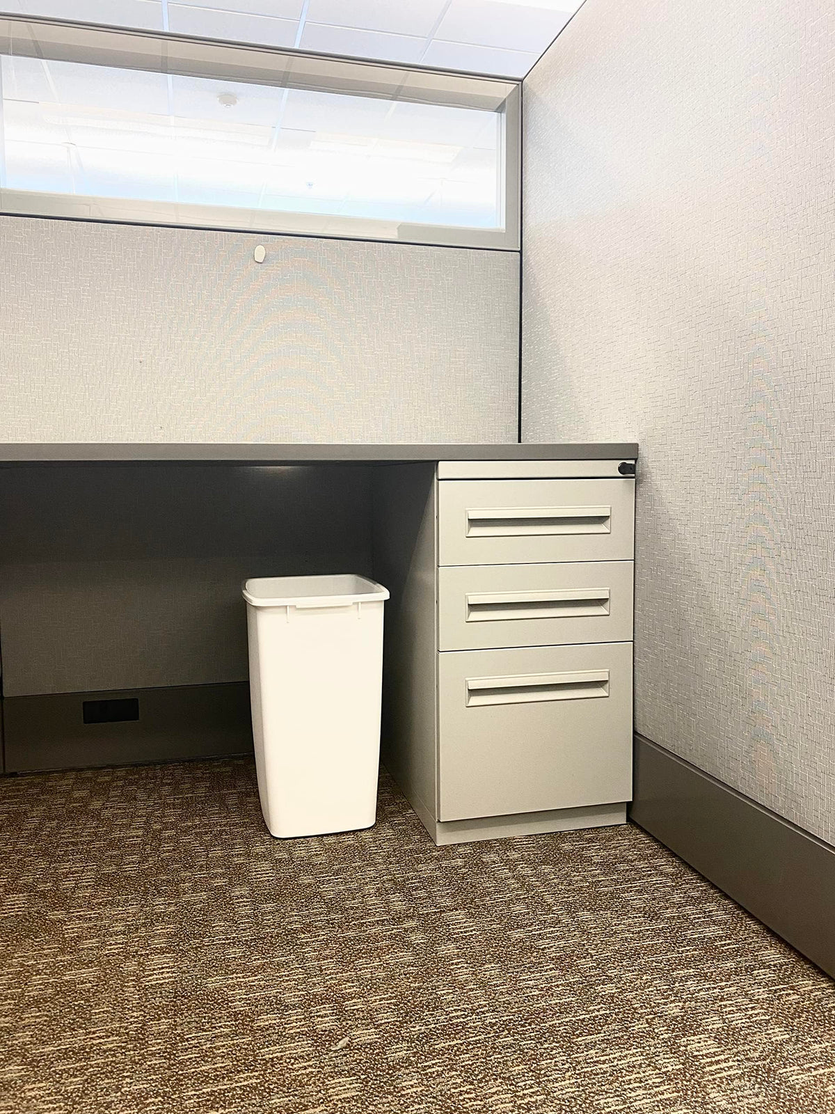 Rubbermaid trash bin with tough rim resists daily bumps.