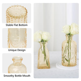 Ruckace wedding table setups use gold mini vases for a chic look.