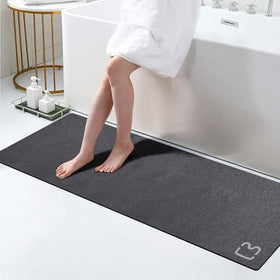 RUERYA dark grey bath mat with diatomite surface absorbs water quickly.