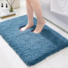 Ruggnovea bath rug with non-slip blue backing provides secure footing on tile floors.