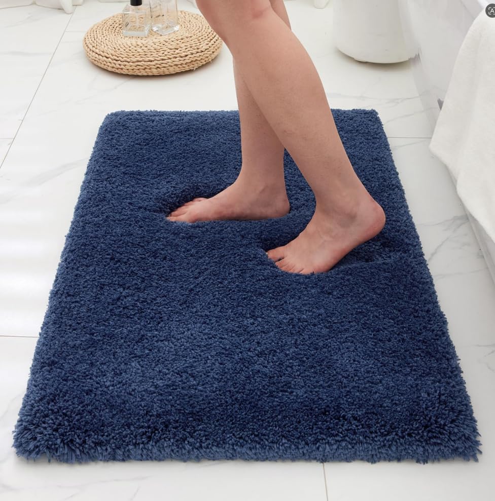 Ruggnovea navy bathroom rug with non-slip backing for secure footing.