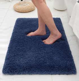Ruggnovea navy bathroom rug with non-slip backing for secure footing.