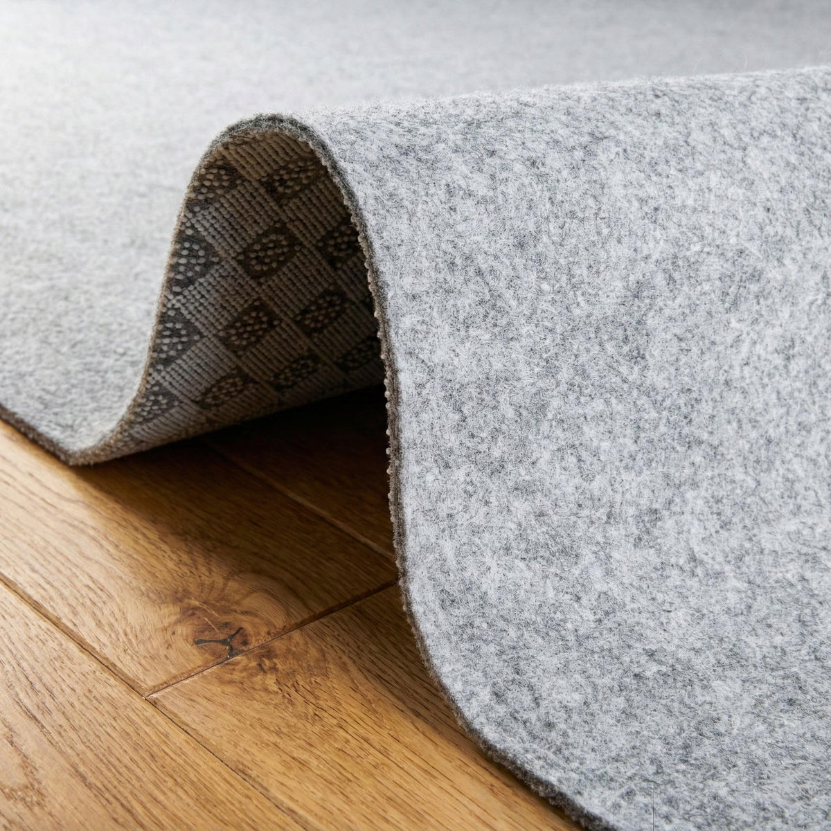 Rugs.com Everyday Performance Rug Pad reveals 1/4 inch thickness detail.