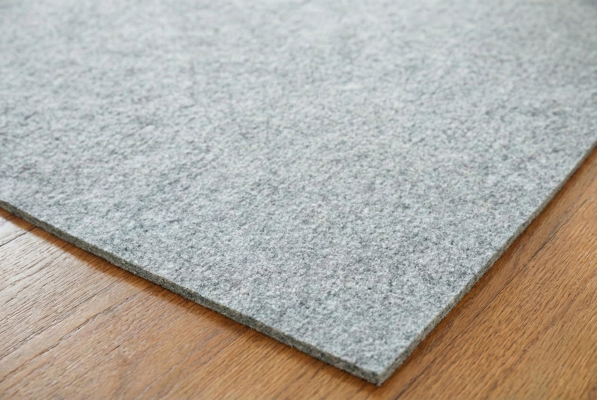 Rugs.com Everyday Performance Rug Pad placed under rug ready for use.