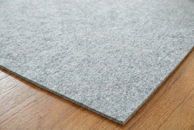 Rugs.com Everyday Performance Rug Pad placed under rug ready for use.