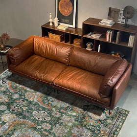 RUGSURE machine-washable rug positioned under a dining table in a cozy room.