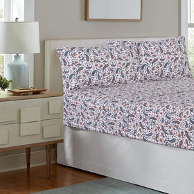 RUVANTI teal paisley sheets draped on bed for inviting look.