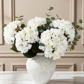 RyddeligHome Real Touch white hydrangea and eucalyptus arrangement adds lifelike elegance to dining tables.