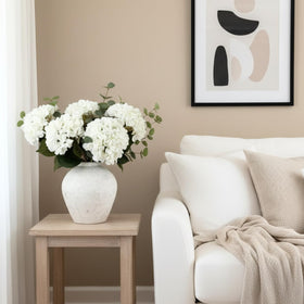 RyddeligHome White hydrangea centerpiece with greenery enhances kitchen island decor for year-round charm.