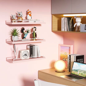 RYOFOBETTO pink and white floating shelves used for plant arrangements and decor.