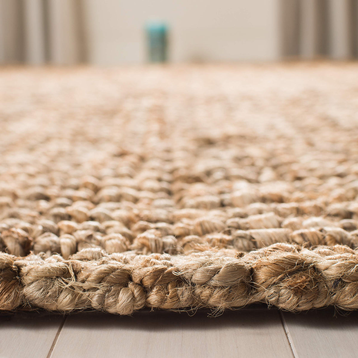 SAFAVIEH natural brown jute rug closeup showing natural fiber variations