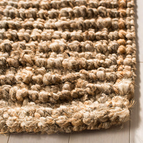 SAFAVIEH NF447A thick pile surface offering subtle cushioning underfoot.
