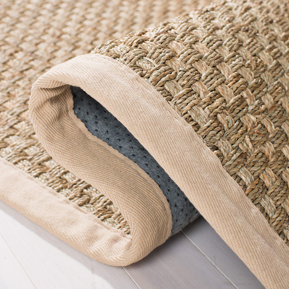 Safavieh NF114A felt-dotted backing offers grip and stability on floors.