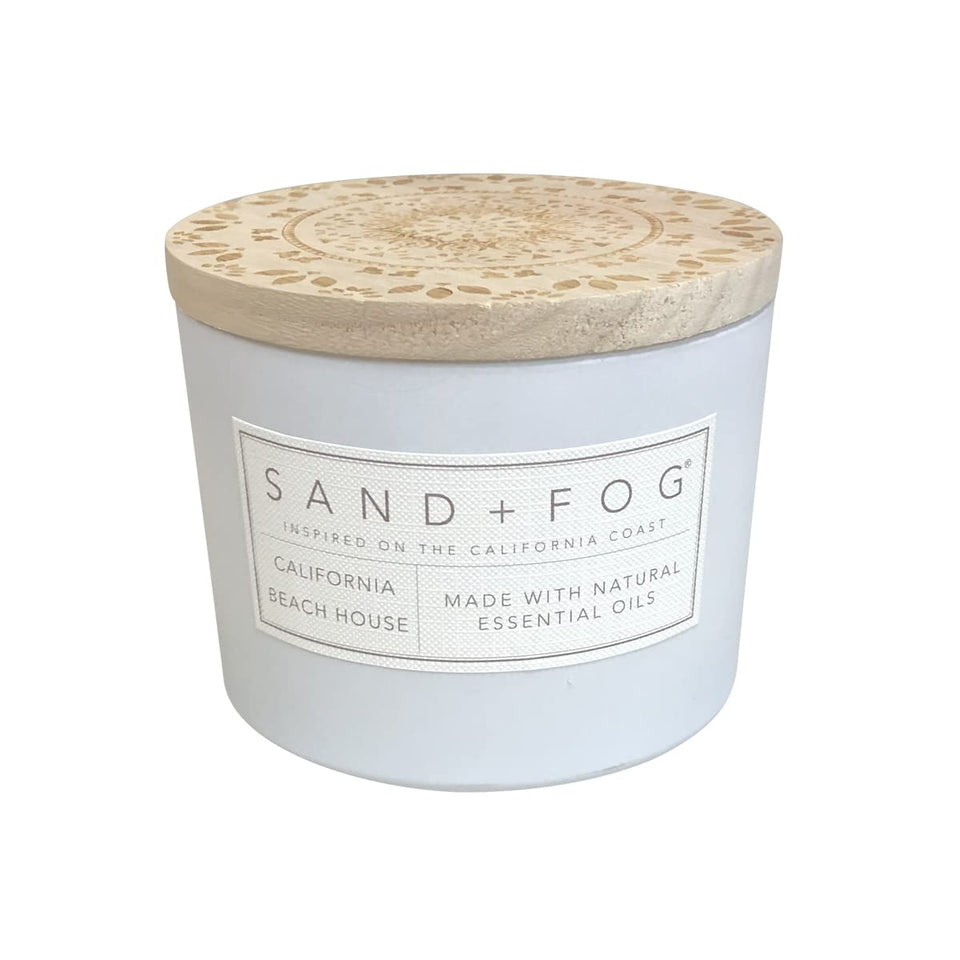 Sand + Fog California Beach House candle on a coffee table enhances living room ambience.