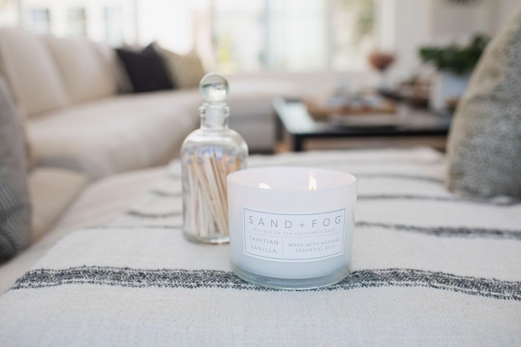 Candle enhances living room ambience with coastal-inspired charm.