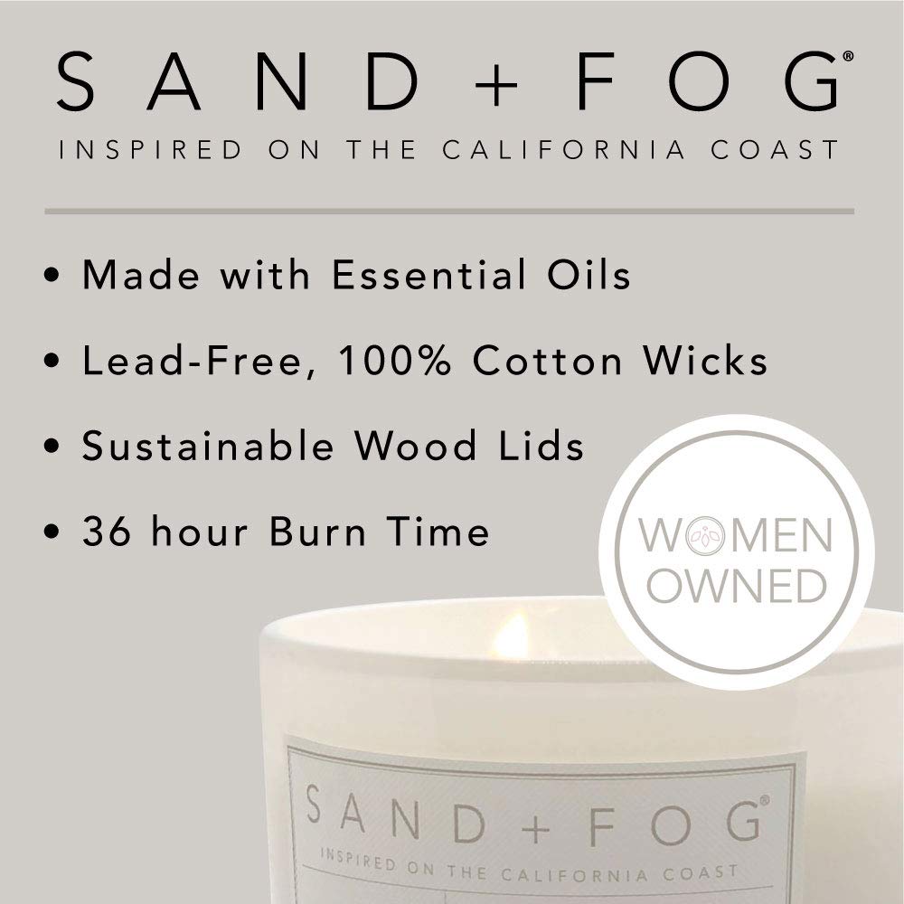 Sand + Fog Teakwood candle burning softly, creating a relaxing atmosphere.