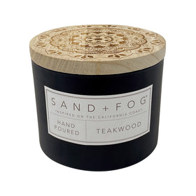 Sand + Fog Teakwood candle in a glass jar with lid, perfect for cozy living spaces.