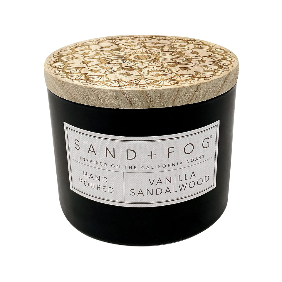 Sand + Fog Vanilla Sandalwood candle with lid art creates refined ambiance.