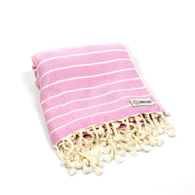 Sand Cloud Gocek Pink towel texture shown for premium Turkish cotton feel.
