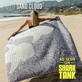 Sand Cloud Whale XL towel rolled in bag for fast-drying, on-the-go use.