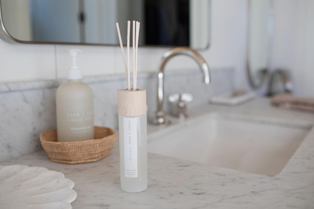 Sand + Fog Ocean Mist diffuser with wood reeds enhancing ambient scent in living spaces