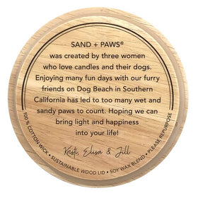 Artisan wood lid detail on Sand + Paws candle enhances display charm.