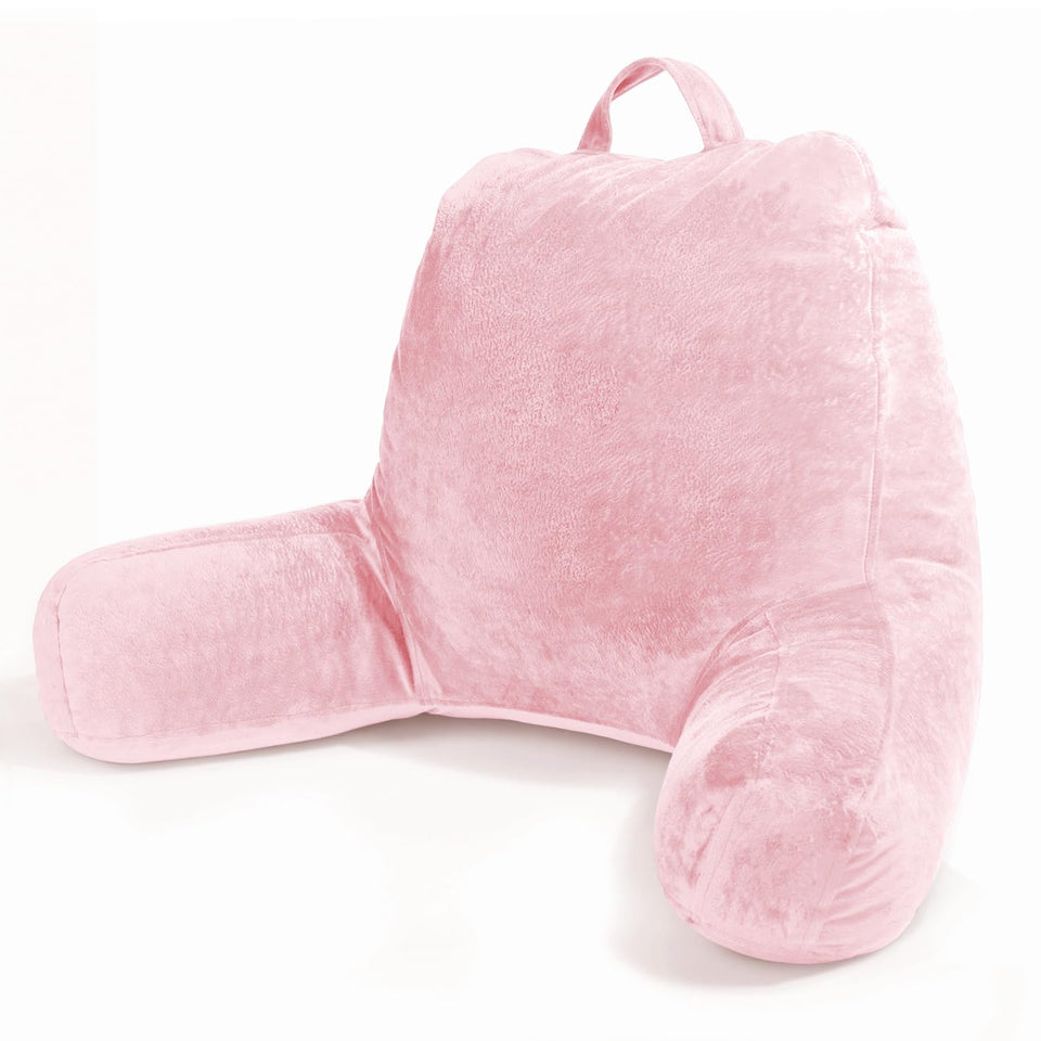 Sasttie reading pillow with pink velvet cover resting on a bed for comfortable reading