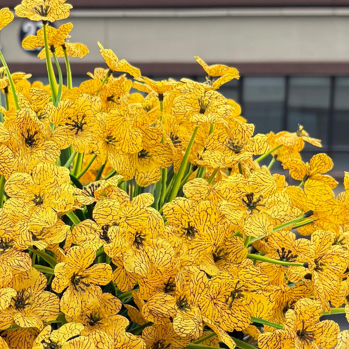 Satefello yellow artificial blooms stay vibrant all season.