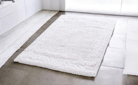 Savi Home 100% cotton bath rug with high absorbency.
