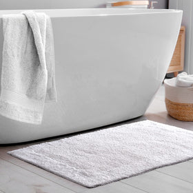 Savi Home hand-tufted bath mat delivers plush comfort on bare feet.