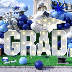 Saxuxu Grad marquee letter frame glows to highlight graduation photo moments.