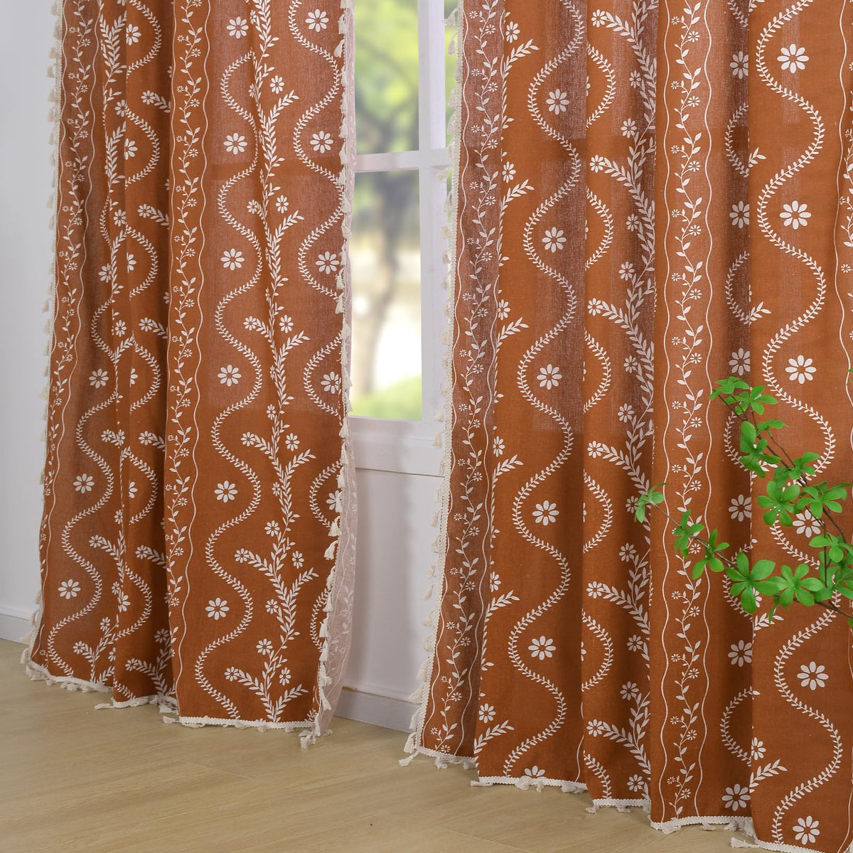 Schweek floral print close-up reveals linen blend texture and burnt orange tones.