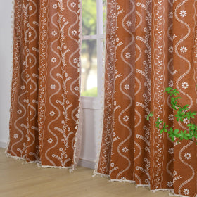 Schweek floral print close-up reveals linen blend texture and burnt orange tones.
