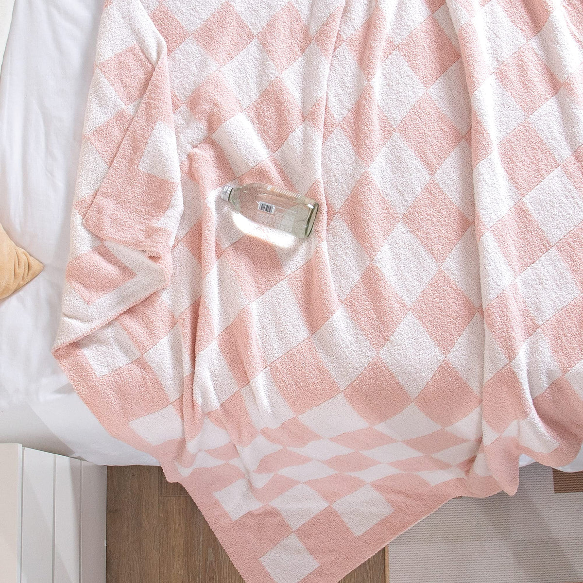 SeaRoomy pink checkered throw blanket styled for photoshoot setup