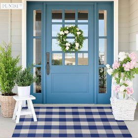 SEEKSEE blue and white porch rug adds layered texture to a welcoming outdoor space.