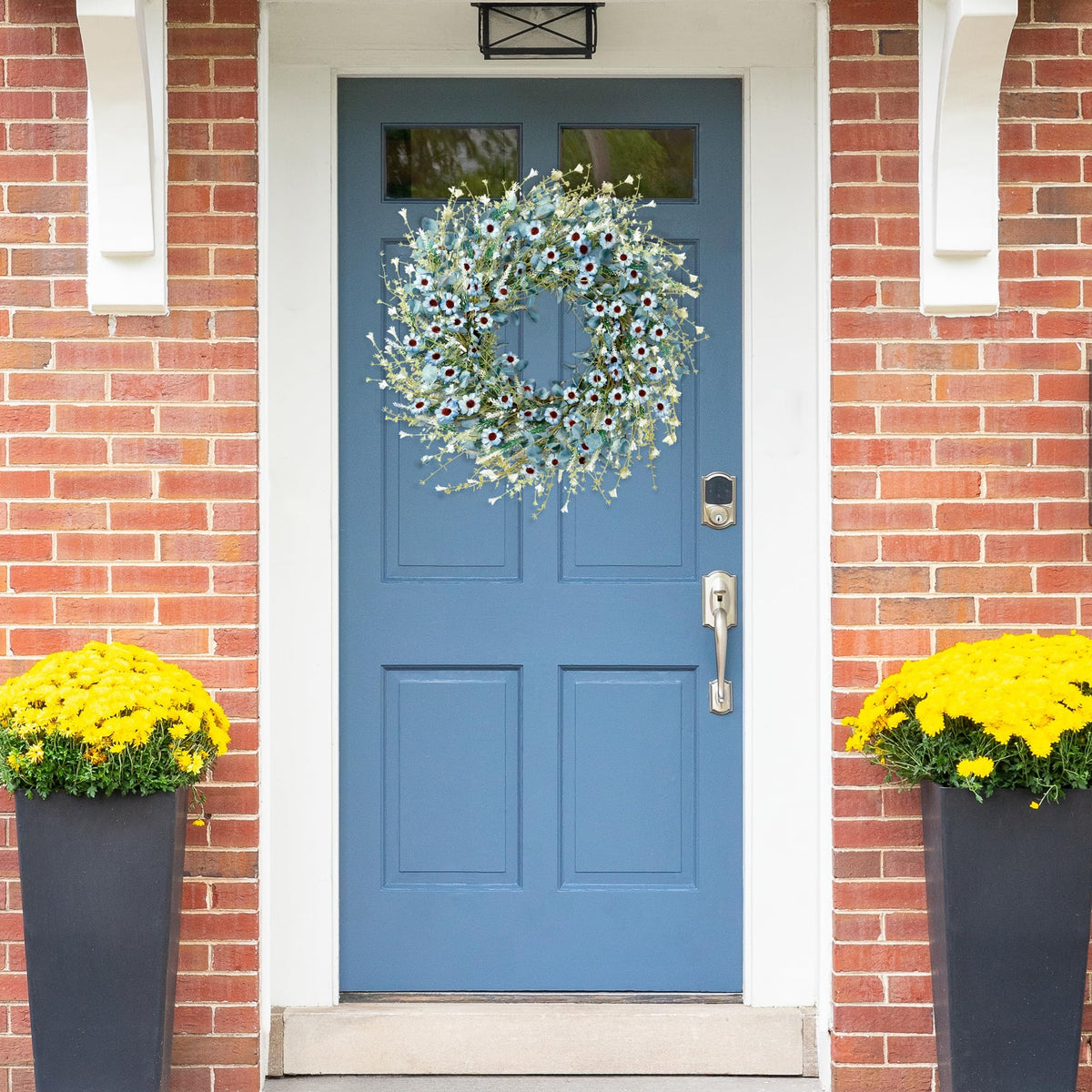 Sggvecsy Blue Daisy Wreath shows lush green foliage and clustered flowers.