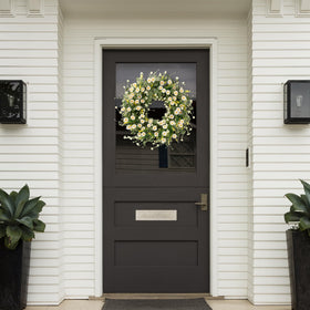 Sggvecsy wreath above fireplace adds cottage-inspired elegance to living spaces.