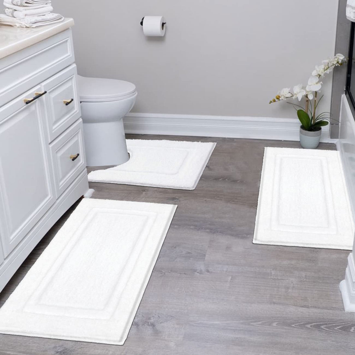 SHACOS white 16x24 bath mat for plush foot comfort beside the sink