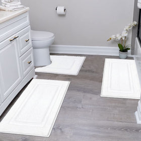 SHACOS white 16x24 bath mat for plush foot comfort beside the sink