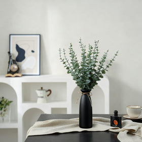 Shanranplus artificial eucalyptus stems in ceramic vase offer realistic leaves and maintenance-free elegance.