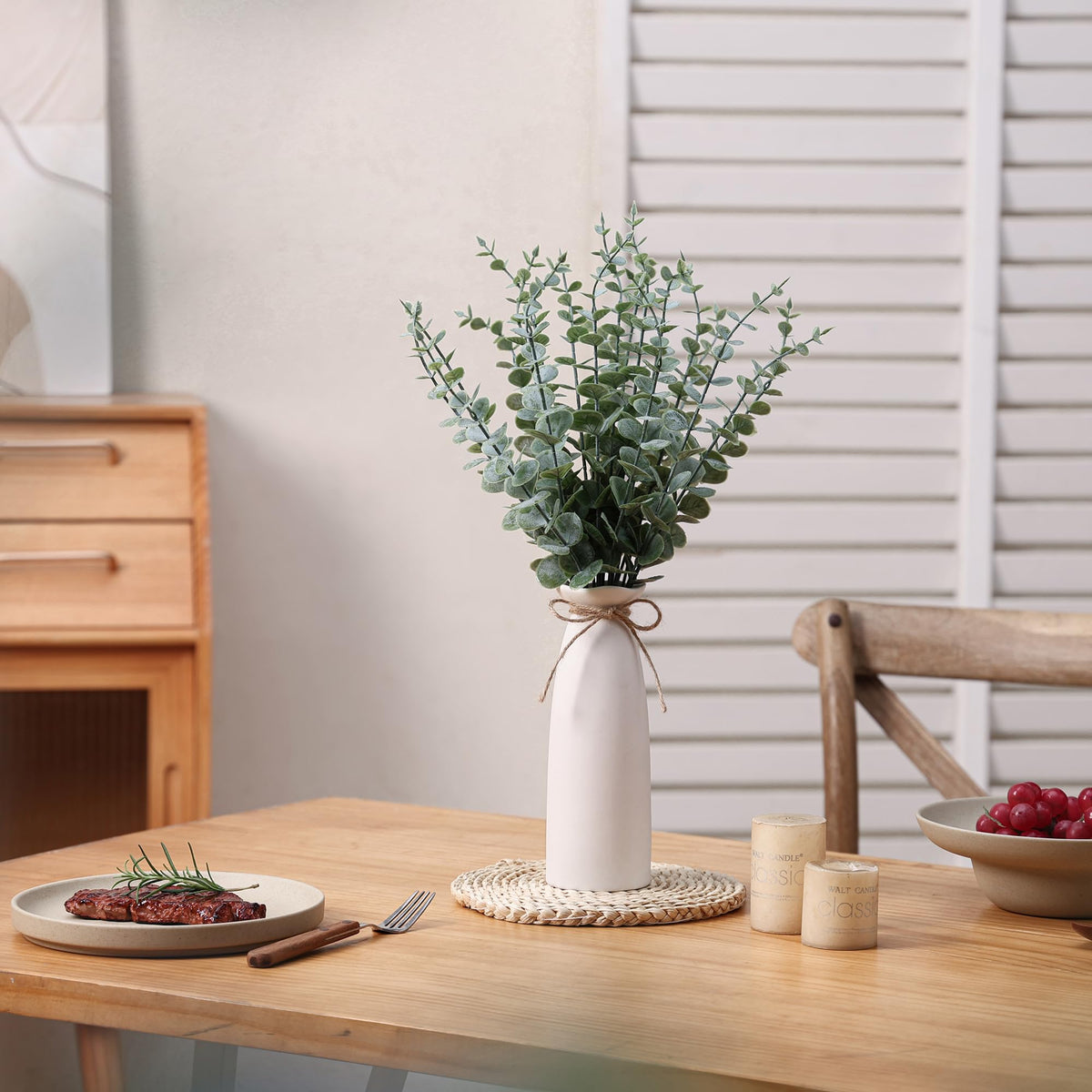 Shanranplus tall ceramic vase with green eucalyptus stems.