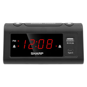 Sharp alarm clock bedside display with bright red digits for easy reading from across the room.