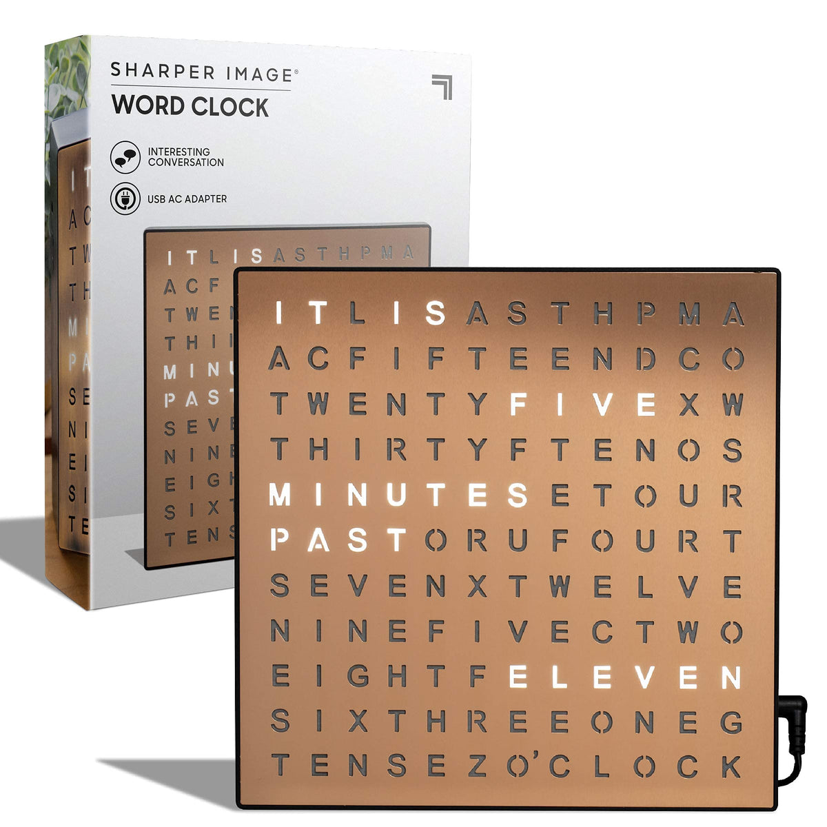 Sharper Image LED Word Clock copper finish glow on a tidy desk for quick time reading