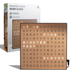 Sharper Image LED Word Clock copper finish glow on a tidy desk for quick time reading