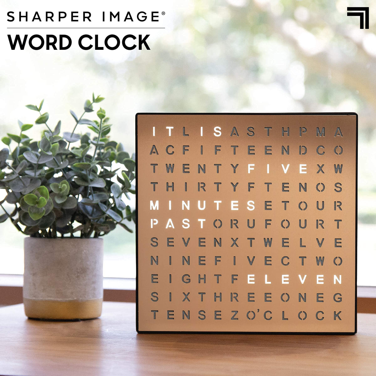 Sharper Image LED Word Clock mounted on wall with copper finish elevating decor