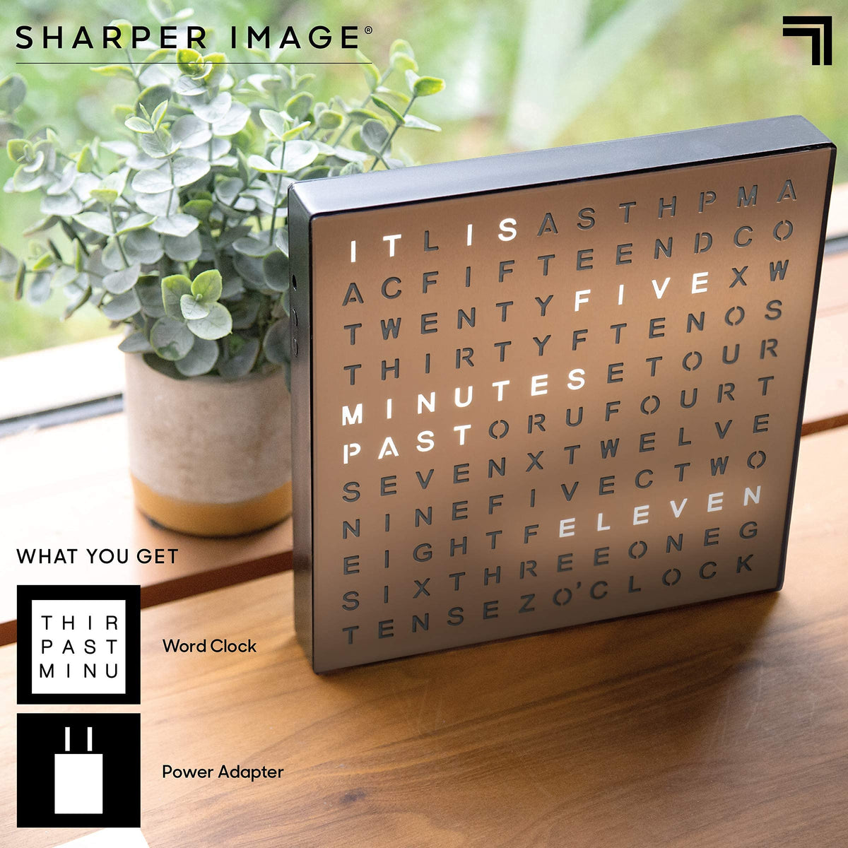 Nightstand scene shows Sharper Image LED Word Clock blending with decor and soft light
